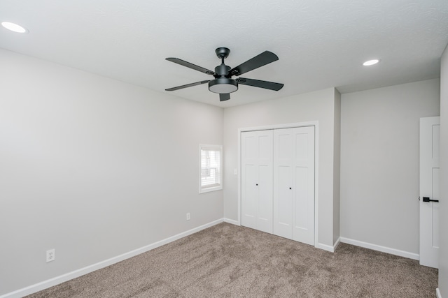 unfurnished bedroom with a closet, ceiling fan, and carpet flooring