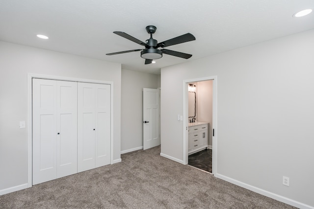 unfurnished bedroom featuring ceiling fan, a closet, connected bathroom, and carpet