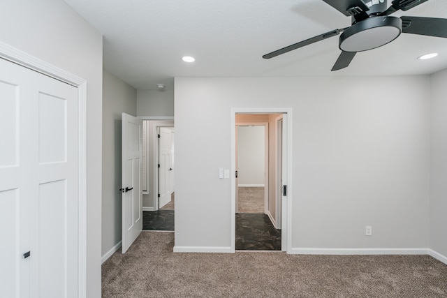 unfurnished bedroom featuring ceiling fan and carpet flooring