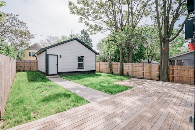 wooden terrace featuring an outdoor structure and a lawn