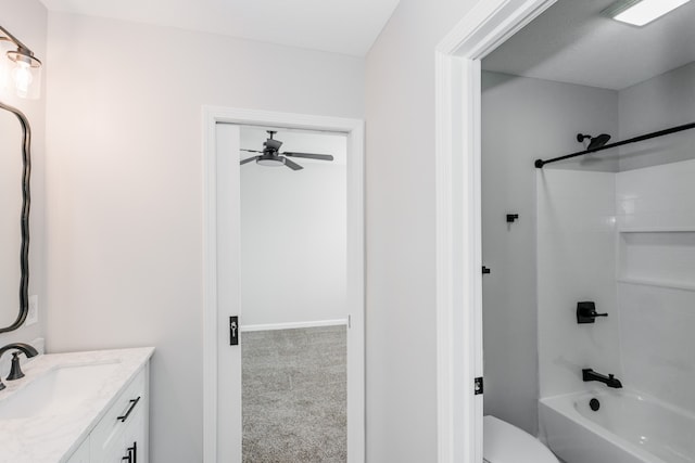 full bathroom featuring washtub / shower combination, vanity, and toilet