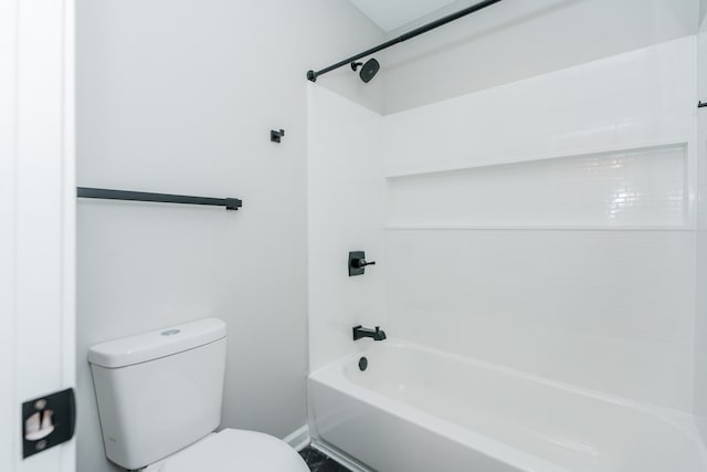 bathroom with shower / bathing tub combination and toilet