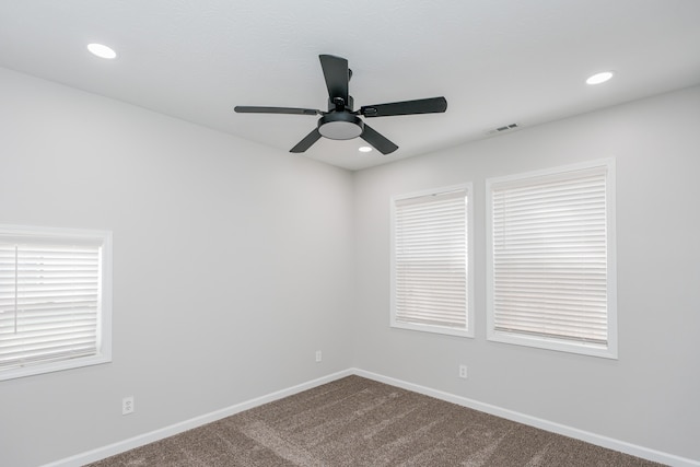 empty room with ceiling fan and carpet