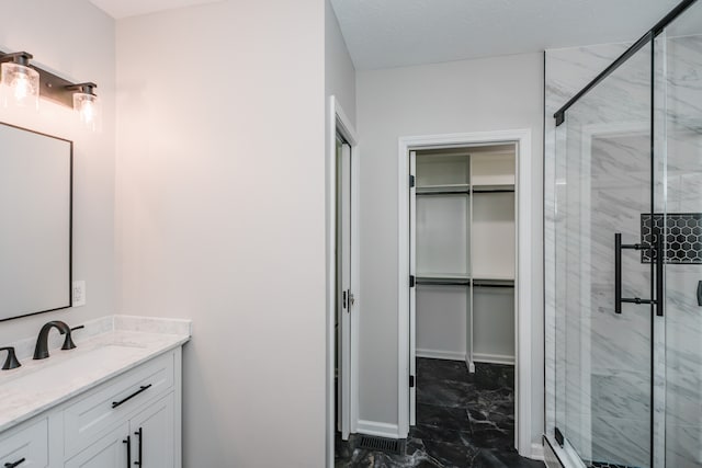 bathroom with vanity and a shower with door