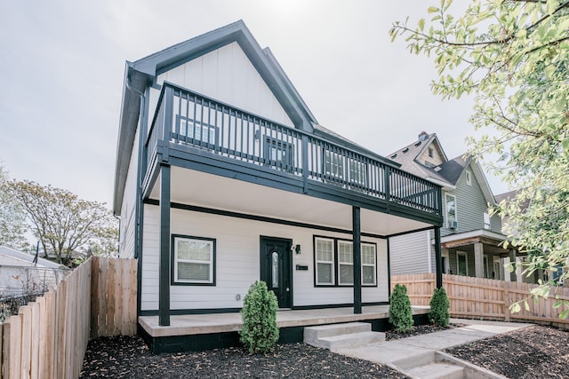 back of house with a balcony and a porch