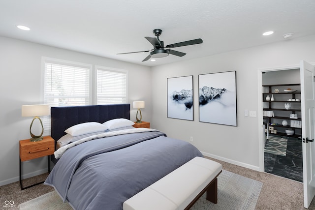 bedroom with light carpet, a textured ceiling, and ceiling fan