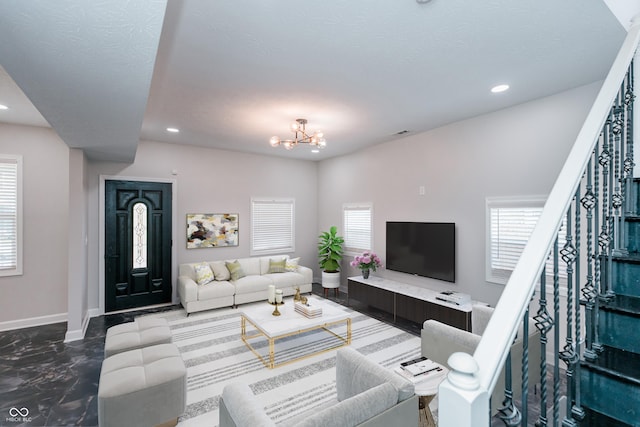 living room with a notable chandelier and a textured ceiling