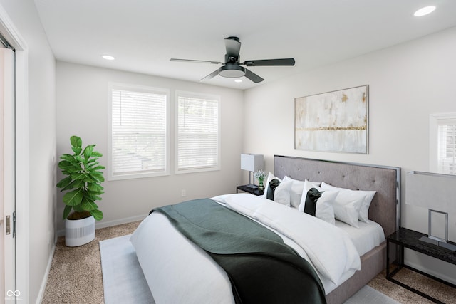 bedroom with multiple windows, carpet floors, and ceiling fan