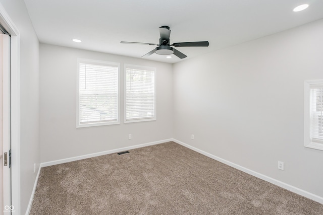 unfurnished room with carpet and ceiling fan