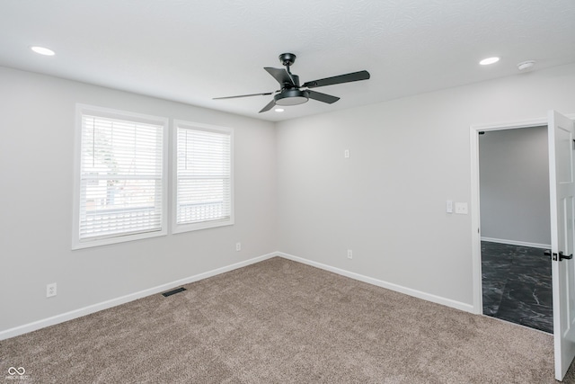 empty room with carpet floors and ceiling fan