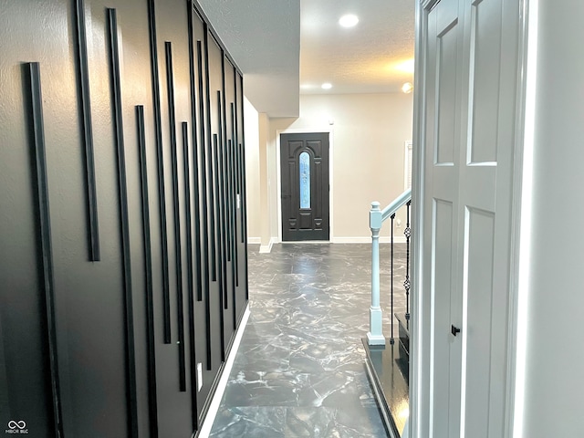 hallway with a textured ceiling