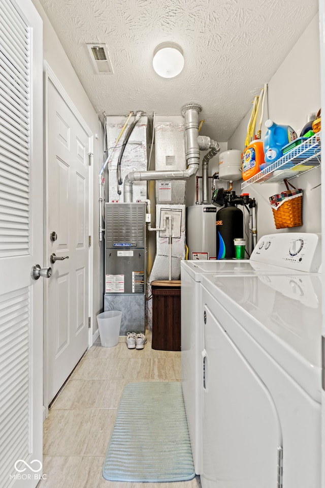 5220 Ariana Ct, Indianapolis, IN 46227 - washroom with washing machine and clothes dryer, gas water heater, and a textured ceiling