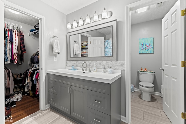 5220 Ariana Ct, Indianapolis, IN 46227 - bathroom with vanity, a spacious closet, and wood finished floors