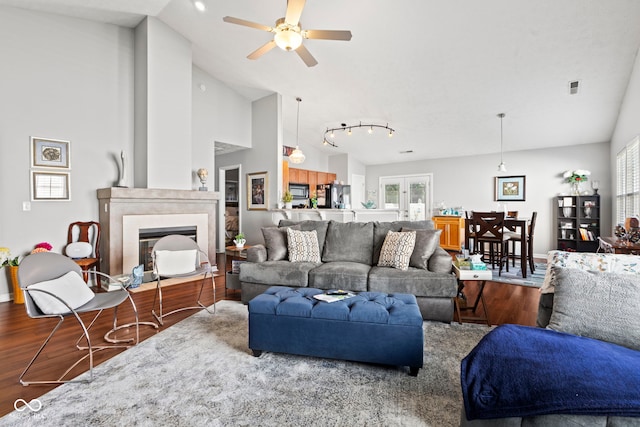 5220 Ariana Ct, Indianapolis, IN 46227 - living area with wood finished floors, a ceiling fan, a fireplace with flush hearth, and high vaulted ceiling