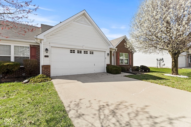 5220 Ariana Ct, Indianapolis, IN 46227 - view of front of home featuring brick siding, an attached garage, concrete driveway, and a front lawn