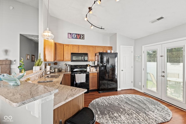 5220 Ariana Ct, Indianapolis, IN 46227 - kitchen with black appliances, a peninsula, light stone countertops, dark wood-style flooring, and high vaulted ceiling