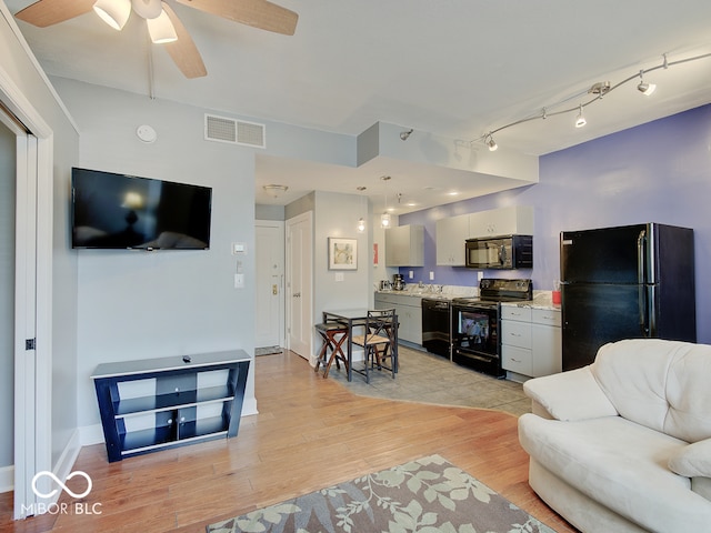 living room with ceiling fan and light wood-type flooring