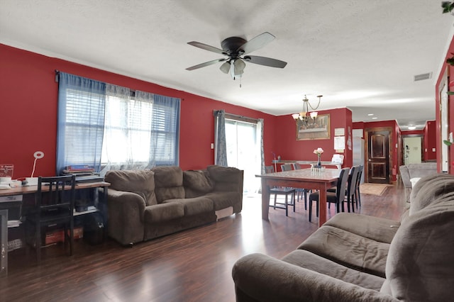 living room featuring a textured ceiling, dark hardwood / wood-style floors, and ceiling fan with notable chandelier