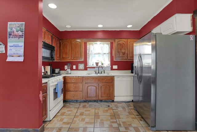 kitchen with white appliances, sink, and light tile floors