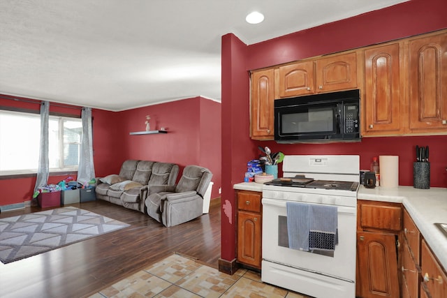 kitchen featuring light tile flooring and white range oven