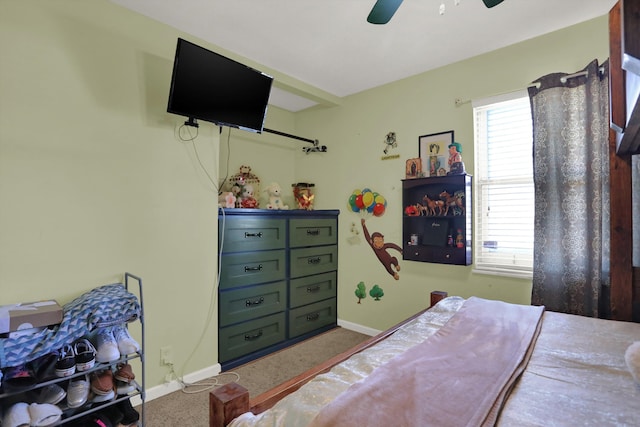 bedroom featuring ceiling fan and carpet