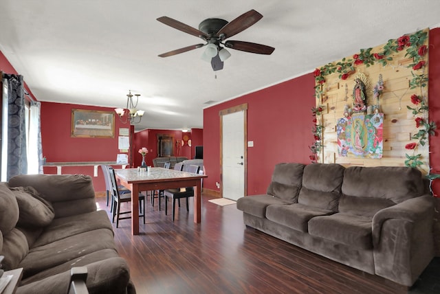 living room with dark wood-type flooring and ceiling fan with notable chandelier