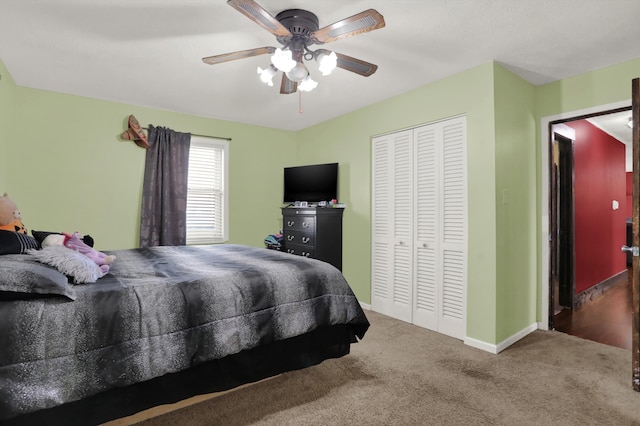 bedroom with ceiling fan, a closet, and dark wood-type flooring