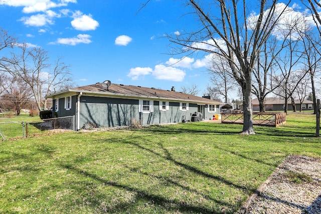 rear view of house featuring a lawn