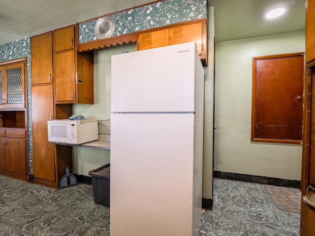 kitchen featuring white appliances and dark tile flooring