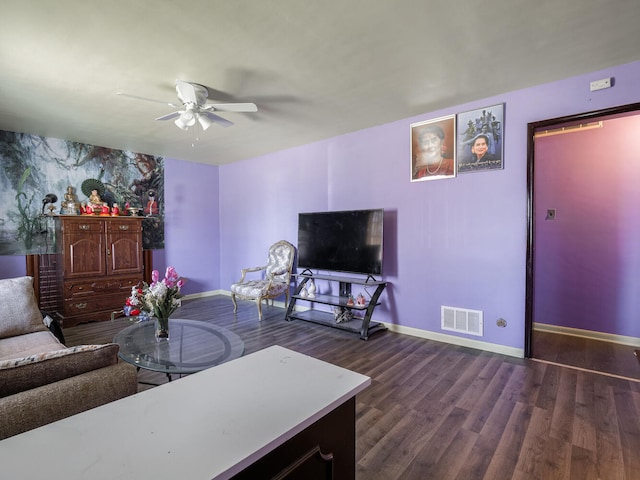 living room with ceiling fan and dark hardwood / wood-style flooring