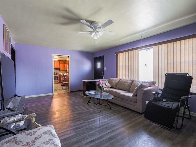 living room with ceiling fan and dark hardwood / wood-style floors