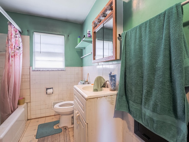 full bathroom featuring toilet, tile walls, tile flooring, and vanity