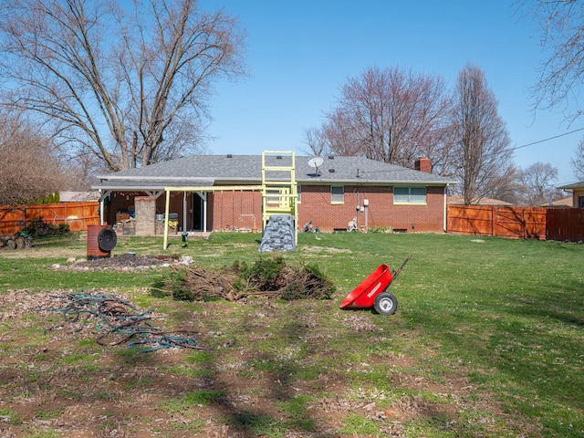 rear view of house featuring a yard