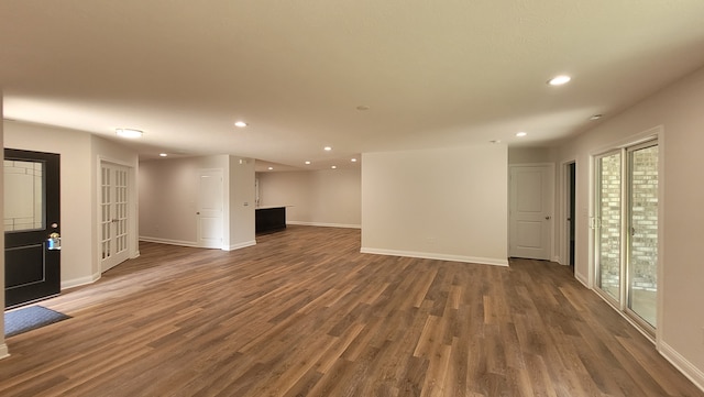 unfurnished living room featuring dark hardwood / wood-style floors