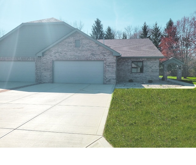 single story home with a front yard and a garage