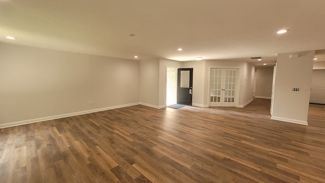 unfurnished living room featuring dark hardwood / wood-style floors