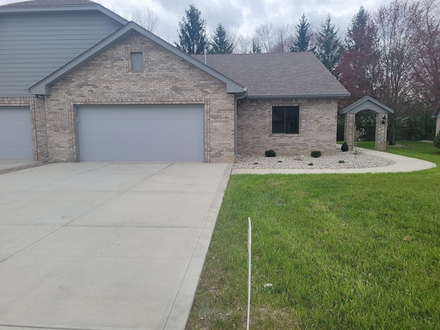 view of front facade with a front yard and a garage