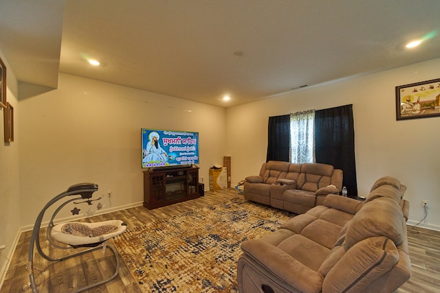 living room featuring dark hardwood / wood-style floors and a fireplace