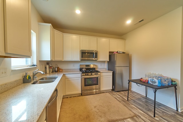 kitchen with white cabinets, sink, and stainless steel appliances