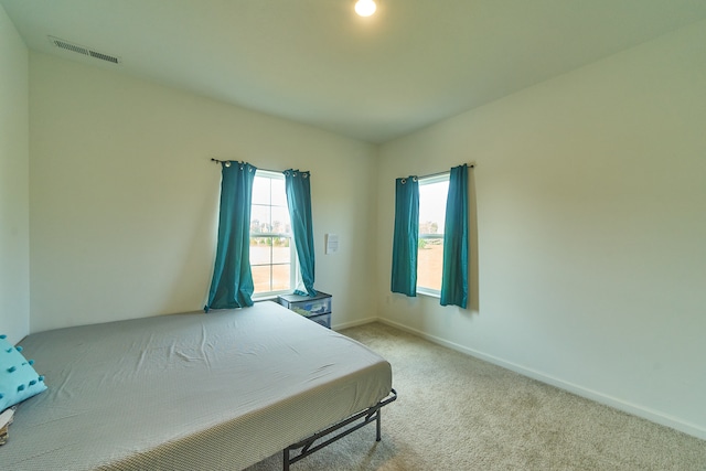 bedroom with light colored carpet