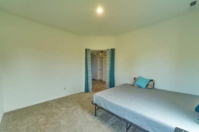 bedroom featuring light carpet