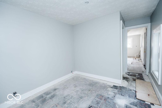 unfurnished room featuring a textured ceiling