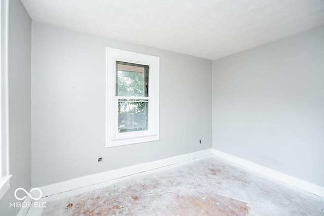 unfurnished room featuring a textured ceiling