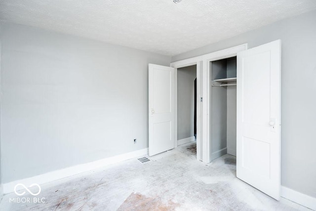 unfurnished bedroom with a closet and a textured ceiling