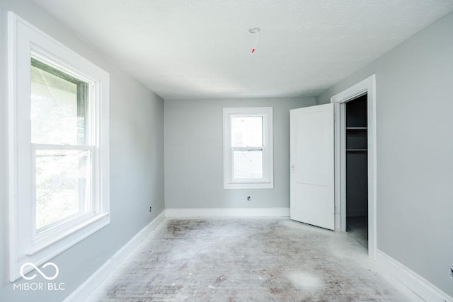 unfurnished bedroom with multiple windows