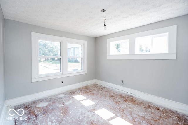 unfurnished room featuring a textured ceiling