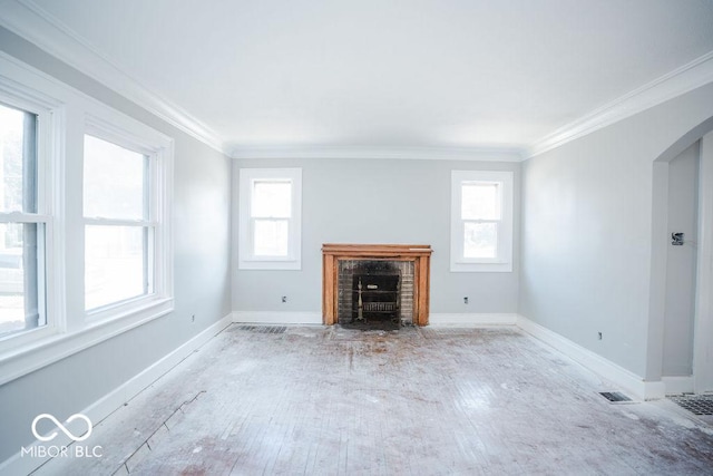 unfurnished living room featuring crown molding