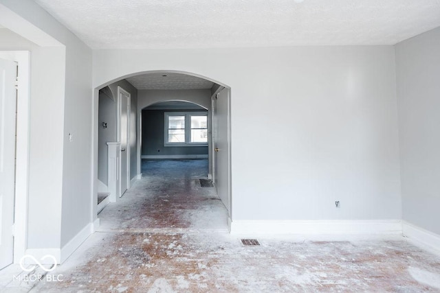 hallway with a textured ceiling