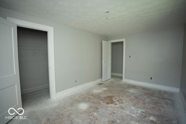 unfurnished bedroom featuring a closet and a textured ceiling