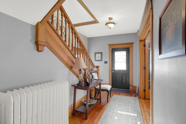 entryway with radiator heating unit and light wood-type flooring